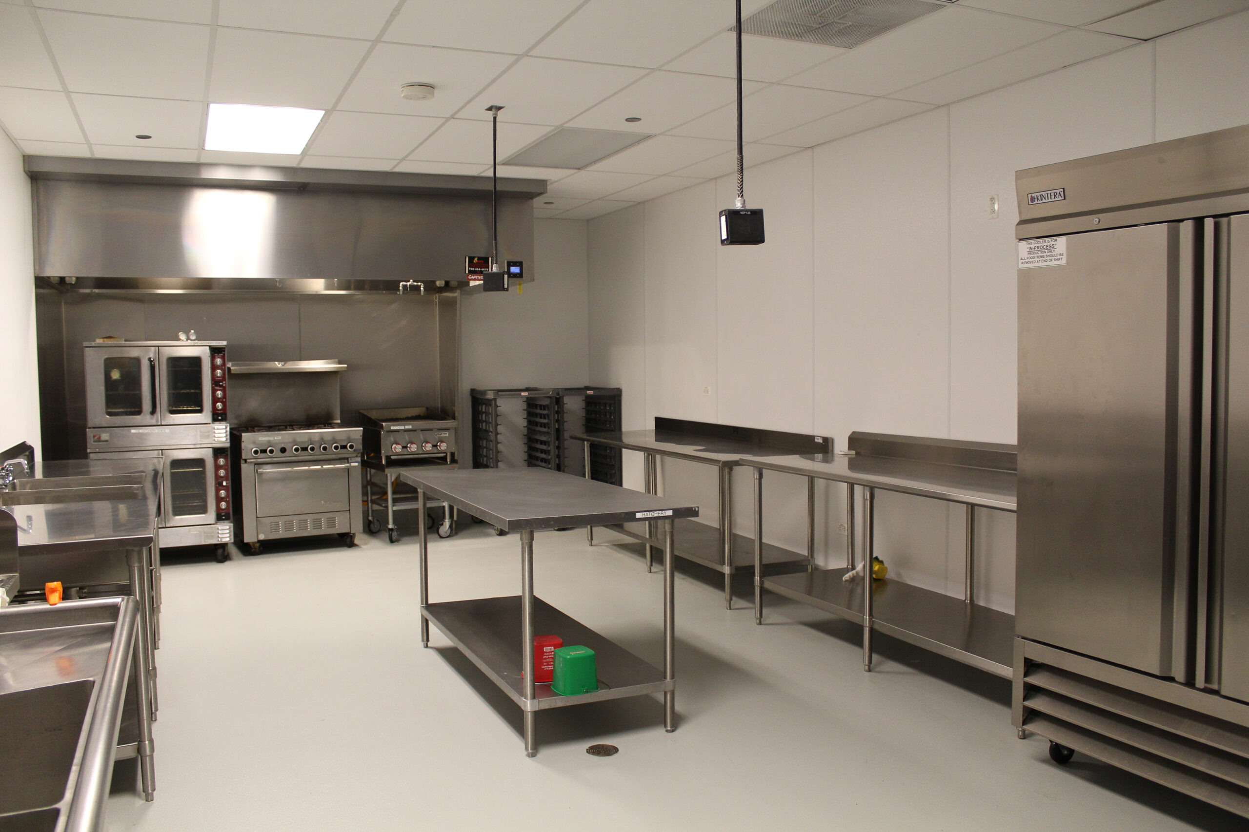 A small kitchen with a small table in the middle